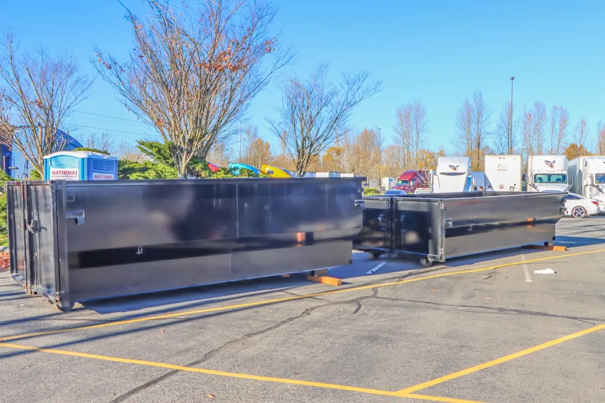 Professional dumpster rental service with roll-off container on residential driveway in Marysville